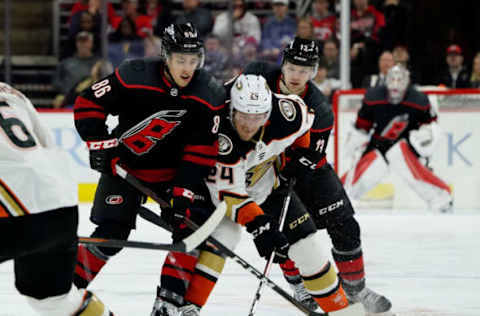 RALEIGH, NC – JANUARY 17: Teuvo Teravainen #86 of the Carolina Hurricanes battles for the puck with Carter Rowney #24 of the Anaheim Ducks during an NHL game on January 17, 2020 at PNC Arena in Raleigh, North Carolina. (Photo by Gregg Forwerck/NHLI via Getty Images)