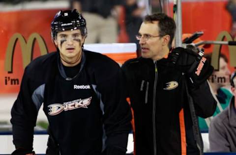 LOS ANGELES, CA – JANUARY 24: Luca Sbisa #5 of the Anaheim Ducks talks to assistant coach Scott Niedermayer during team practice for the 2014 Coors Light NHL Stadium Series against Los Angeles Kings at Dodger Stadium on January 24, 2014, in Los Angeles, California. (Photo by Jeff Vinnick/NHLI via Getty Images)