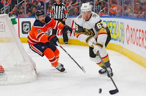 Apr 16, 2022; Edmonton, Alberta, CAN; Vegas Golden Knights forward Evgenii Dadonov (63) looks to make a pass in front of Edmonton Oilers defensemen Kris Russell (6) during the second period at Rogers Place. Mandatory Credit: Perry Nelson-USA TODAY Sports