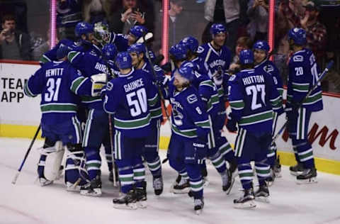 Oct 18, 2016; Vancouver, British Columbia, CAN; The Vancouver Canucks celebrate the win against the St. Louis Blues during overtime at Rogers Arena. The Vancouver Canucks won 2-1 in overtime. Mandatory Credit: Anne-Marie Sorvin-USA TODAY Sports