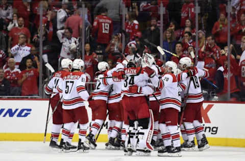 WASHINGTON, DC – APRIL 24: Brock McGinn #23 of the Carolina Hurricanes celebrates with his teammates after scoring the game winning goal in the second overtime period against the Washington Capitals in Game Seven of the Eastern Conference First Round during the 2019 NHL Stanley Cup Playoffs at Capital One Arena on April 24, 2019 in Washington, DC. The Hurricanes defeated the Capitals 4-3 in the second overtime period to move on to Round Two of the Stanley Cup playoffs. (Photo by Patrick McDermott/NHLI via Getty Images)