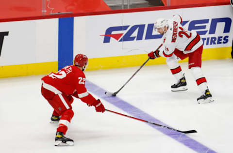 Jan 14, 2021; Detroit, Michigan, USA; Carolina Hurricanes right wing Nino Niederreiter (21) skates with the puck defended by Detroit Red Wings defenseman Patrik Nemeth (22) in the third period at Little Caesars Arena. Mandatory Credit: Rick Osentoski-USA TODAY Sports