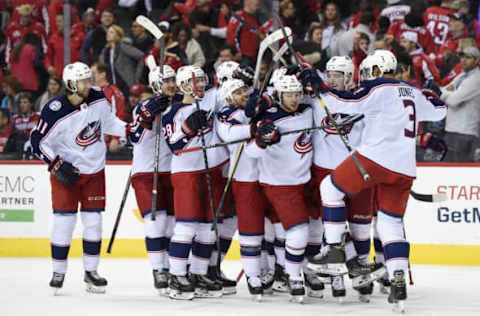 WASHINGTON, DC – JANUARY 12: Artemi Panarin #9 of the Columbus Blue Jackets celebrates with his teammates after scoring the game winning goal in overtime to defeat the Washington Capitals 2-1 at Capital One Arena on January 12, 2019 in Washington, DC. (Photo by Patrick McDermott/NHLI via Getty Images)