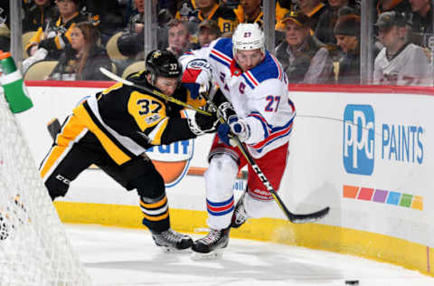 PITTSBURGH, PA: Ryan McDonagh #27 of the New York Rangers battles against Carter Rowney #37 of the Pittsburgh Penguins on December 5, 2017. (Photo by Joe Sargent/NHLI via Getty Images)