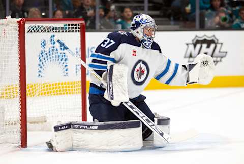 Mar 28, 2023; San Jose, California, USA; Winnipeg Jets goaltender Connor Hellebuyck (37) reaches out for a shot on goal during the second period against the San Jose Sharks at SAP Center at San Jose. Mandatory Credit: D. Ross Cameron-USA TODAY Sports