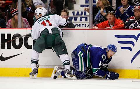 Zach Parise of the Minnesota Wild checks Chris Tanev of the Vancouver Canucks (Photo by Ben Nelms/Getty Images)