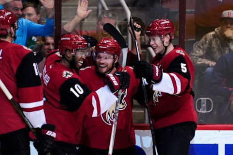 Feb 18, 2016; Glendale, AZ, USA; Arizona Coyotes center Max Domi (16) celebrates scoring with left wing Anthony Duclair (10) and defenseman Connor Murphy (5) during the second period against the Dallas Stars at Gila River Arena. Mandatory Credit: Matt Kartozian-USA TODAY Sports