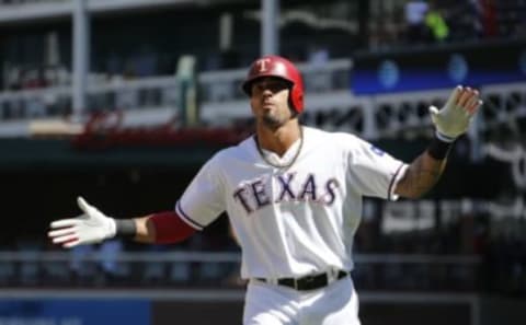 Aug 11, 2016; Arlington, TX, USA; Texas Rangers center fielder Ian Desmond (20) reacts to driving in a run with a field