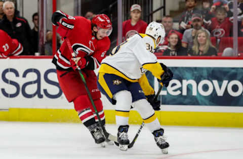 RALEIGH, NC – SEPTEMBER 27: Carolina Hurricanes left wing Erik Haula (56) slips away from Nashville Predators defenseman Jeremy Davies (38) during an NHL Pre-Season game between the Carolina Hurricanes and the Nashville Predators on September 27, 2019 at the PNC Arena in Raleigh, NC. (Photo by John McCreary/Icon Sportswire via Getty Images)