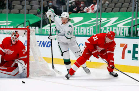 DALLAS, TEXAS – APRIL 19: Roope Hintz #24 of the Dallas Stars skates for the puck against Dennis Cholowski #21 of the Detroit Red Wings as Thomas Greiss #29 of the Detroit Red Wings defends in the second period at American Airlines Center on April 19, 2021 in Dallas, Texas. (Photo by Tom Pennington/Getty Images)