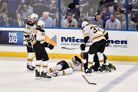 TAMPA, FL – MAY 06: Teammates and trainer take care of an injured Boston Bruins right wing David Backes (42) during the second period of an NHL Stanley Cup Eastern Conference Playoffs game between the Boston Bruins and the Tampa Bay Lightning on May 06, 2018, at Amalie Arena in Tampa, FL. (Photo by Roy K. Miller/Icon Sportswire via Getty Images)