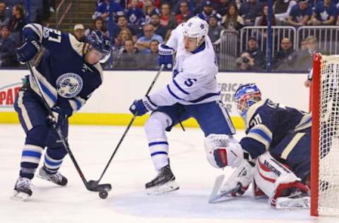 Feb 15, 2017; Columbus, OH, USA; Columbus Blue Jackets defenseman Ryan Murray (27) defends against Toronto Maple Leafs left wing Matt Martin (15) in front of Columbus Blue Jackets goalie Joonas Korpisalo (70) in the first period at Nationwide Arena. Mandatory Credit: Aaron Doster-USA TODAY Sports