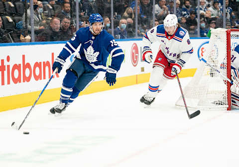 Nov 18, 2021; Toronto, Ontario, CAN; Toronto Maple Leafs center Alexander Kerfoot (15) skates with the puck as New York Rangers defenseman Jacob Trouba (8) gives chase during the first period at Scotiabank Arena. Mandatory Credit: Nick Turchiaro-USA TODAY Sports