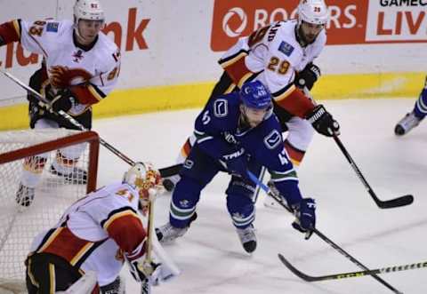 Oct 15, 2016; Vancouver, British Columbia, CAN; Vancouver Canucks forward Sven Baertschi (47) moves the puck against Calgary Flames goaltender Chad Johnson (31) during the third period at Rogers Arena. The Vancouver Canucks won 2-1 in a shootout. Mandatory Credit: Anne-Marie Sorvin-USA TODAY Sports