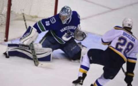 Mar 19, 2016; Vancouver, British Columbia, CAN; Vancouver Canucks goaltender Ryan Miller (30) stops a shot by St. Louis Blues forward Kyle Brodziak (28) during the second period at Rogers Arena. Mandatory Credit: Anne-Marie Sorvin-USA TODAY Sports