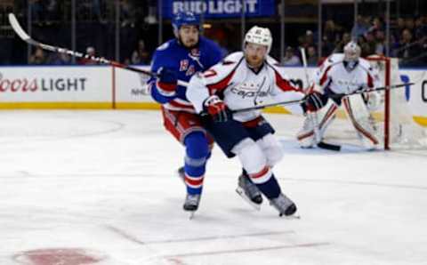 Feb 19, 2017; New York, NY, USA; New York Rangers center Mika Zibanejad (93) battles for the puck with Washington Capitals defenseman Karl Alzner (27) during the second period at Madison Square Garden. Mandatory Credit: Adam Hunger-USA TODAY Sports