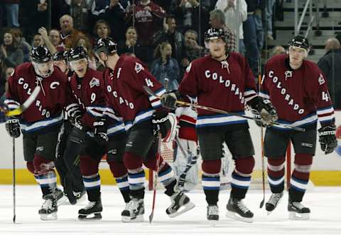 DENVER – JANUARY 6: Paul Kariya #9 of the Colorado Avalanche celebrates with Joe Sakic #19, Rob Blake #4, Teemu Selanne #8 and Martin Skoula #41 (Photo by Brian Bahr/Getty Images)