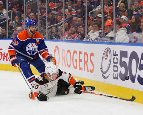 EDMONTON, CANADA – NOVEMBER 26: Darnell Nurse #25 of the Edmonton Oilers checks Jackson LaCombe #60 of the Anaheim Ducks in the second period on November 26, 2023 at Rogers Place in Edmonton, Alberta, Canada. (Photo by Lawrence Scott/Getty Images)