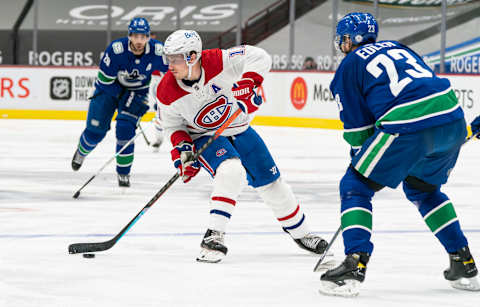 VANCOUVER, BC – MARCH 08: Brendan Gallagher #11 of the Montreal Canadiens tries to get past Alex Edler #23 of the Vancouver Canucks during NHL hockey action at Rogers Arena on March 8, 2021 in Vancouver, Canada. (Photo by Rich Lam/Getty Images)