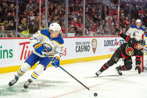 Oct 24, 2023; Ottawa, Ontario, CAN; Buffalo Sabres center Casey Mittelstadt (37) controls the puck as Ottawa Senators center Josh Norris (9) trips on a stick in the first period at the Canadian Tire Centre. Mandatory Credit: Marc DesRosiers-USA TODAY Sports