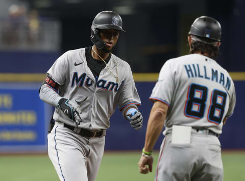 Sep 26, 2021; St. Petersburg, Florida, USA; Miami Marlins first baseman Lewin Diaz (68) is congratulated by third base coach Trey Hillman (88) as he hits a home run during the ninth inning against the Tampa Bay Rays at Tropicana Field. Mandatory Credit: Kim Klement-USA TODAY Sports