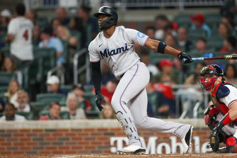 Apr 25, 2023; Atlanta, Georgia, USA; Miami Marlins right fielder Jorge Soler (12) hits a single against the Atlanta Braves in eighth inning at Truist Park. Mandatory Credit: Brett Davis-USA TODAY Sports