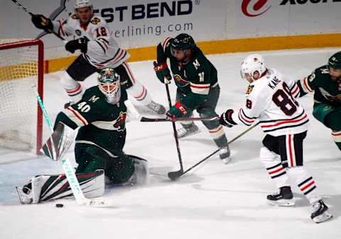 ST. PAUL, MN – OCTOBER 11: Devan Dubnyk #40 of the Minnesota Wild makes a save on Patrick Kane #88 of the Chicago Blackhawks as Zach Parise #11 of the Minnesota Wild defends and Alex DeBrincat #12 of the Chicago Blackhawks looks on during a game between the Minnesota Wild and Chicago Black Hawks at Xcel Energy Center on October 11, 2018 in St. Paul, Minnesota. The Wild defeated the Black Hawks 4-3 in overtime.(Photo by Bruce Kluckhohn/NHLI via Getty Images)