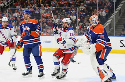 EDMONTON, CANADA – OCTOBER 26: Vincent Trocheck #16 of the New York Rangers dances between Evan Bouchard #2 and Stuart Skinner #74 of the Edmonton Oilers in the first period on October 26, 2023 at Rogers Place in Edmonton, Alberta, Canada. (Photo by Lawrence Scott/Getty Images)