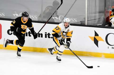 Jan 26, 2021; Boston, Massachusetts, USA; Pittsburgh Penguins center Sidney Crosby (87) skates with the puck in front of Boston Bruins center Charlie Coyle (13) during the second period at the TD Garden. Mandatory Credit: Brian Fluharty-USA TODAY Sports