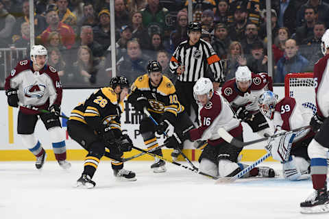 BOSTON, MA – DECEMBER 7: Nikkita Zadorov #16 of the Colorado Avalanche fights for the puck against Par Lindholm #26 and Anders Bjork #10 of the Boston Bruins at the TD Garden on December 7, 2019 in Boston, Massachusetts. (Photo by Steve Babineau/NHLI via Getty Images)