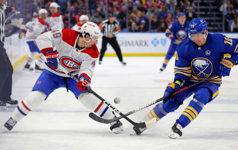 Oct 23, 2023; Buffalo, New York, USA; Montreal Canadiens left wing Rafael Harvey-Pinard (49) and Buffalo Sabres defenseman Henri Jokiharju (10) go after a loose puck during the third period at KeyBank Center. Mandatory Credit: Timothy T. Ludwig-USA TODAY Sports