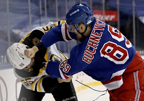 Jeremy Lauzon #55 of the Boston Bruins and Pavel Buchnevich #89 of the New York Rangers fight in the second period a (Photo by Elsa/Getty Images)