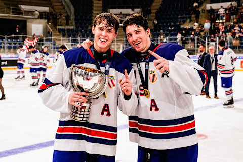 Will Smith (L) and Ryan Leonard (R) with trophy during the U18 Ice Hockey World Championship Final. (Photo by Jari Pestelacci/Eurasia Sport Images/Getty Images)