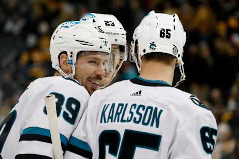 Jan 28, 2023; Pittsburgh, Pennsylvania, USA; San Jose Sharks center Logan Couture (39) reacts with left wing Oskar Lindblom (23) and defenseman Erik Karlsson (65) after Couture scored an empty net goal against the Pittsburgh Penguins during the third period at PPG Paints Arena. The Sharks won 6-4. Mandatory Credit: Charles LeClaire-USA TODAY Sports