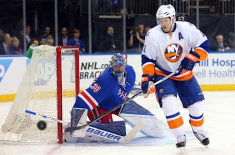 Apr 7, 2016; New York, NY, USA; New York Rangers goalie Henrik Lundqvist (30) and New York Islanders right wing Kyle Okposo (21) watch a puck go by the net during the first period at Madison Square Garden. Mandatory Credit: Brad Penner-USA TODAY Sports