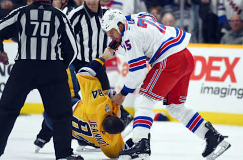 Nov 12, 2022; Nashville, Tennessee, USA; Nashville Predators left wing Tanner Jeannot (84) and New York Rangers right wing Ryan Reaves (75) fight during the third period at Bridgestone Arena. Mandatory Credit: Christopher Hanewinckel-USA TODAY Sports