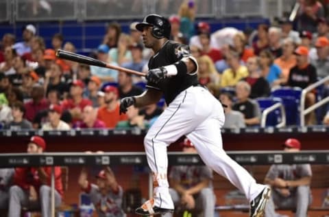 Jul 30, 2016; Miami, FL, USA; Miami Marlins center fielder Marcell Ozuna (13) connects for a two run home run during the first inning against the St. Louis Cardinals at Marlins Park. Mandatory Credit: Steve Mitchell-USA TODAY Sports