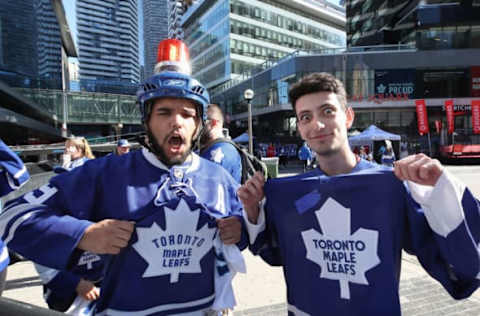 Apr 23, 2017; Toronto, Ontario, CAN; A couple of Toronto Maple Leafs fans gather at Maple Leaf Square plaza before the start of their team’s game against the Washington Capitals in game six of the first round of the 2017 Stanley Cup Playoffs at Air Canada Centre. Mandatory Credit: Tom Szczerbowski-USA TODAY Sports