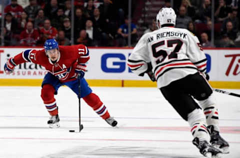 Montreal Canadiens forward Brendan Gallagher (11) plays the puck and Chicago Blackhawks defenseman Trevor van Riemsdyk (57) defends (Eric Bolte-USA TODAY Sports)