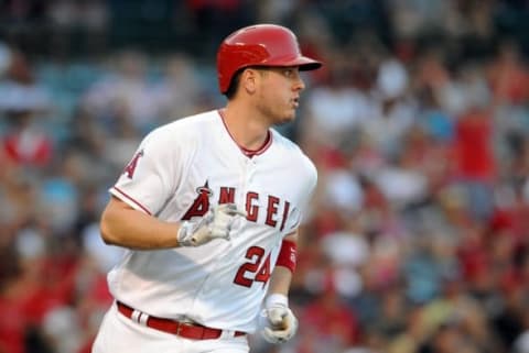 August 31, 2016; Anaheim, CA, USA; Los Angeles Angels first baseman C.J. Cron (24) reaches first after he hits an RBI single in the eighth inning against the Cincinnati Reds at Angel Stadium of Anaheim. Mandatory Credit: Gary A. Vasquez-USA TODAY Sports