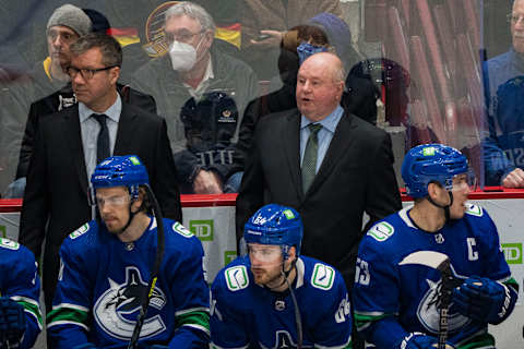 Dec 6, 2021; Vancouver, British Columbia, CAN; Vancouver assistant coach Scott Walker and head coach Bruce Boudreau on the bench during a game against the Los Angeles Kings in the first period at Rogers Arena. Mandatory Credit: Bob Frid-USA TODAY Sports