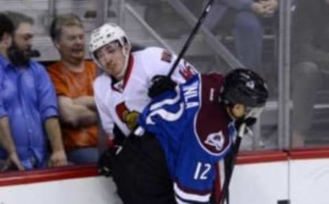 Jan 8, 2015; Denver, CO, USA; Colorado Avalanche right wing Jarome Iginla (12) checks Ottawa Senators defenseman Patrick Wiercioch (46) in the first period at the Pepsi Center. Mandatory Credit: Ron Chenoy-USA TODAY Sports