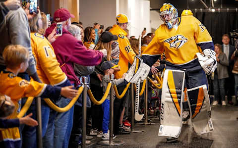 NASHVILLE, TN – NOVEMBER 21: Pekka Rinne #35 of the Nashville Predators high fives fans as he walks to the ice prior to an NHL game against the Vancouver Canucks at Bridgestone Arena on November 21, 2019 in Nashville, Tennessee. (Photo by John Russell/NHLI via Getty Images)