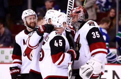 VANCOUVER, BC – FEBRUARY 21: Darcy Kuemper #35 is congratulated by teammates after their overtime win during their NHL game against the Vancouver Canucks at Rogers Arena February 21, 2019 in Vancouver, British Columbia, Canada. (Photo by Jeff Vinnick/NHLI via Getty Images)