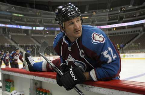 DENVER – SEPTEMBER 22: Adam Foote #52, captain of the Colorado Avalanche, stretches during warm up prior to facing the Los Angeles Kings during preseason NHL action at the Pepsi Center on September 22, 2010 in Denver, Colorado. The Kings defeated the Avalanche 4-2. (Photo by Doug Pensinger/Getty Images)