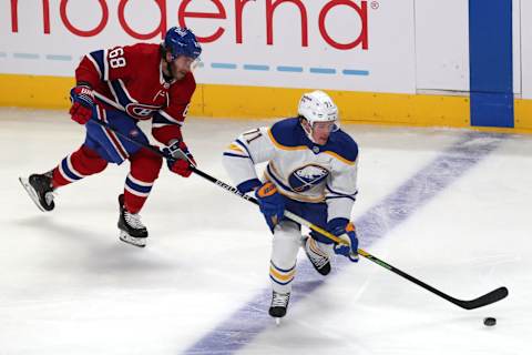 Feb 13, 2022; Montreal, Quebec, CAN; Buffalo Sabres left wing Victor Olofsson (71) plays the puck against Montreal Canadiens center Mike Hoffman (68) during the third period at Bell Centre. Mandatory Credit: Jean-Yves Ahern-USA TODAY Sports