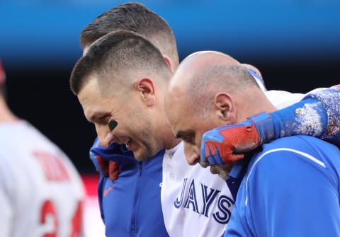 TORONTO, ON – JULY 28: Troy Tulowwitzki #2 of the Toronto Blue Jays is helped off the field by trainers George Poulis and Mike Frostad after injuring his ankle in the third inning during MLB game action against the Los Angeles Angels of Anaheim at Rogers Centre on July 28, 2017 in Toronto, Canada. (Photo by Tom Szczerbowski/Getty Images)