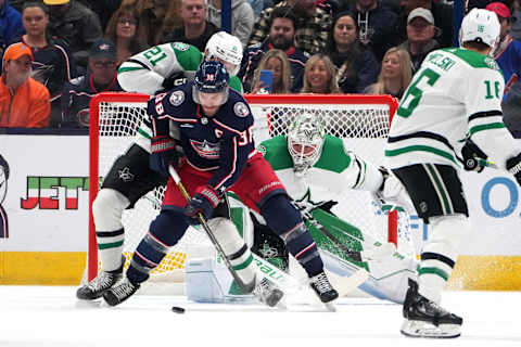 COLUMBUS, OHIO – NOVEMBER 09: Boone Jenner #38 of the Columbus Blue Jackets controls the puck in front of Jason Robertson #21 of the Dallas Stars and Jake Oettinger #29 of the Dallas Stars during the first period at Nationwide Arena on November 09, 2023 in Columbus, Ohio. (Photo by Jason Mowry/Getty Images)