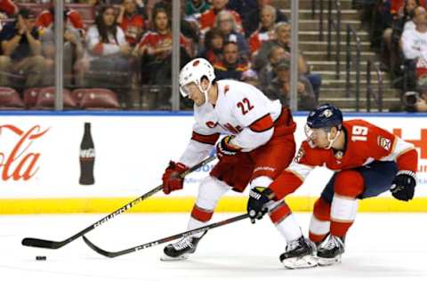 SUNRISE, FLORIDA – OCTOBER 08: Brett Pesce #22 of the Carolina Hurricanes battles for control of the puck with Mike Matheson #19 of the Florida Panthers during the second period at BB&T Center on October 08, 2019 in Sunrise, Florida. (Photo by Michael Reaves/Getty Images)