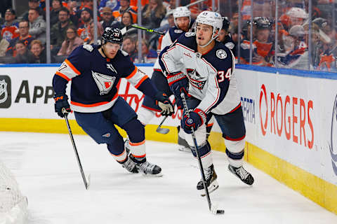 Jan 25, 2023; Edmonton, Alberta, CAN; Columbus Blue Jackets forward Cole Sillinger (34) makes a pass in front of Edmonton Oilers forward Warren Foegele (37) during the third period at Rogers Place. Mandatory Credit: Perry Nelson-USA TODAY Sports